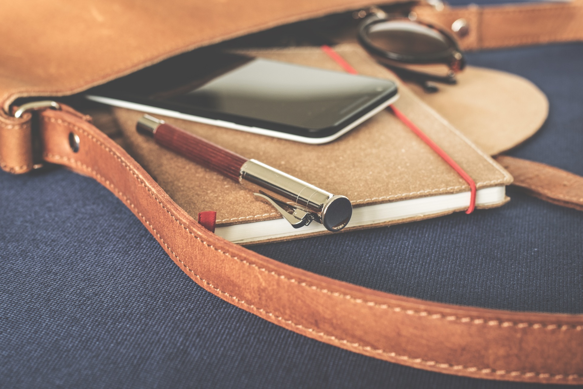 Accessory bag, pen, phone, notebook and sunglasses